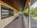 Inviting front porch with traditional columns, neutral paint and comfortable seating perfect for relaxing at 1101 Southland Rd, Venice, FL 34293