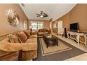 Welcoming living room showcasing neutral paint, a ceiling fan, plush seating and ample natural light at 1101 Southland Rd, Venice, FL 34293
