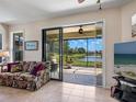 Cozy living room with tile floors and a large sliding glass door leading to the lanai at 11343 Bertolini Dr, Venice, FL 34292