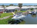 Features a boat in a boat lift with a dock at 120 Villa Dr # 120, Osprey, FL 34229
