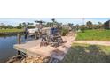 Wooden dock with tiled patio and seating overlooks the water and nearby boats at 120 Villa Dr # 120, Osprey, FL 34229