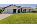 Charming one-story home with well-maintained lawn and inviting curb appeal at 1231 Pine Needle Rd, Venice, FL 34285