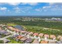 Scenic aerial view of homes, showcasing the community's proximity to lush green spaces and a pond at 1241 Creek Nine Dr, North Port, FL 34291