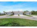 Charming villas featuring well-manicured lawns, attached garages, and inviting landscaping at 12418 Asana Ct, Venice, FL 34293