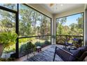 Cozy screened lanai with comfortable seating and lush views of nature at 12418 Asana Ct, Venice, FL 34293