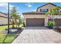 Charming home with a two-car garage, landscaping, and a beautiful paver driveway at 12500 Ghiberti Cir # 101, Venice, FL 34293