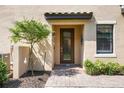 Charming front entrance with manicured landscaping and a decorative glass door at 12500 Ghiberti Cir # 101, Venice, FL 34293