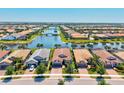 Beautiful aerial view of home and community with lake and bridge at 13511 Esposito St, Venice, FL 34293