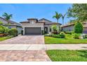 Beautiful home with a well-maintained lawn, landscaped garden and brick driveway at 13511 Esposito St, Venice, FL 34293