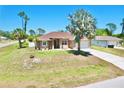 Charming single-story home with a well-manicured lawn and attached two-car garage at 1510 Haffenberg Ave, North Port, FL 34288