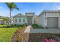 Charming single-story home with a well-manicured lawn and a welcoming double door entrance at 17324 Sandpearl Rd, Venice, FL 34293