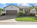 Charming single-story home features a well-manicured lawn and lovely landscaping at 2000 Gardenia Ave, Port Charlotte, FL 33953