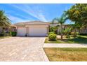 Well maintained home with a three car garage, beautiful landscaping and brick paved driveway at 20126 Elegante Ct, Venice, FL 34293