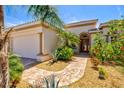 Beautiful front entrance with brick walkway, mature landscaping and a three car garage at 20126 Elegante Ct, Venice, FL 34293