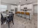 Spacious open-concept kitchen with an island bar that seats four, with a dining area to the left at 20285 Symphony Pl, Venice, FL 34293