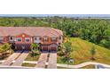 Aerial view of townhomes with lush landscaping and convenient two-car garages at 20290 Lagente Cir, Venice, FL 34293
