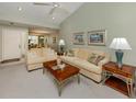 Spacious living room with neutral decor, vaulted ceiling, and large sofas at 229 Southampton Drive # 290, Venice, FL 34293