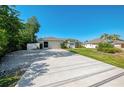 Front exterior of house, driveway and meticulously maintained front lawn at 23516 Peachland Blvd, Port Charlotte, FL 33954