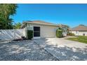 Exterior of home featuring a 2-car garage and verdant shrubbery at 23516 Peachland Blvd, Port Charlotte, FL 33954