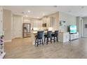 Open-concept kitchen features stainless steel appliances and a breakfast bar at 268 Ibiza Loop, Venice, FL 34292