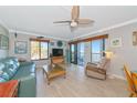Comfortable living room with water views, tile floors, ceiling fan, and access to the screened-in porch at 2955 N Beach Rd # A422, Englewood, FL 34223