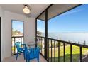 This screened-in porch features an open-air view of the water with seating for relaxation at 2955 N Beach Rd # A422, Englewood, FL 34223