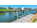 This dock shows a canal with a boat lift along a scenic waterway, perfect for boating enthusiasts at 322 Oakwood Cir, Englewood, FL 34223