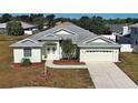 An eye-level front exterior showcasing the home's manicured lawn and welcoming double door entrance at 4062 Green Tree Ave, Sarasota, FL 34233