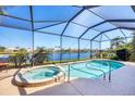 Inviting screened-in pool and spa boasting stunning lake views, creating a private oasis at 4326 Corso Venetia Blvd, Venice, FL 34293