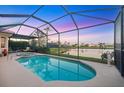 Beautiful screened-in pool and spa area with scenic lake views, ideal for outdoor enjoyment at 4326 Corso Venetia Blvd, Venice, FL 34293