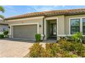 Beautiful single-story home showcasing a terracotta tile roof and well-maintained front yard at 5585 Semolino St, Nokomis, FL 34275
