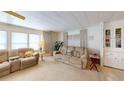 Cozy living room featuring plush seating, natural light, and neutral carpet at 5619 Bayshore Rd # 421, Palmetto, FL 34221