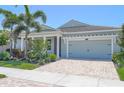 Inviting two-car garage with paver driveway and charming curb appeal at 5632 Long Shore Loop, Sarasota, FL 34238
