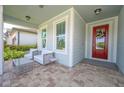 Relaxing front porch seating area with views of the entryway and neighborhood at 5632 Long Shore Loop, Sarasota, FL 34238