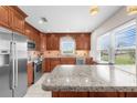 Modern kitchen boasts a granite island, stainless steel appliances, and bright natural light at 5800 Sabal Trace Dr # 101, North Port, FL 34287