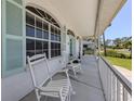 Relaxing front porch with rocking chairs and view of the neighborhood at 5931 Plover Rd, Venice, FL 34293