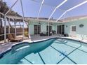 Beautiful backyard pool area with screened-in patio, perfect for outdoor entertaining and relaxation at 5931 Plover Rd, Venice, FL 34293