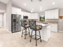 Bright kitchen featuring stainless steel appliances, granite countertops, and a central island at 6126 Spinnaker Blvd, Englewood, FL 34224