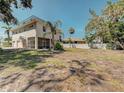 Spacious backyard featuring a home with a screened-in porch and two-car garage at 770 Yale St, Englewood, FL 34223