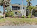 Charming two-story home with a screened-in porch and a well-maintained front lawn at 770 Yale St, Englewood, FL 34223