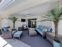 Relaxing covered patio featuring wicker furniture, ceiling fan, and seamless access to the indoors at 791 Cumberland Rd, Venice, FL 34293