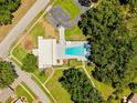 Aerial view of community pool, clubhouse, parking lot and neatly manicured grounds at 810 Anchorage Ln, Palm Harbor, FL 34685