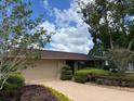 Charming single-story home with a well-manicured lawn and mature trees at 810 Anchorage Ln, Palm Harbor, FL 34685