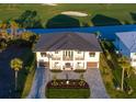 Breathtaking aerial view of a luxurious property featuring a dark roof, manicured landscaping, and a paved driveway at 9810 Eagle Preserve Dr, Englewood, FL 34224