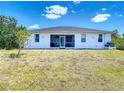 Expansive backyard featuring a screened in porch and an expansive grassy area at 10153 Gasparilla Rd, Placida, FL 33946