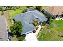 From above, a house with mature landscaping and a well-kept lawn presents stunning curb appeal at 1124 W Hillsborough Blvd, North Port, FL 34288