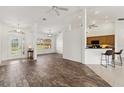 Spacious living room featuring wood-look floors, natural light, and an open-concept design at 113 Mark Twain Ln, Rotonda West, FL 33947