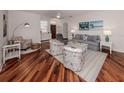 Bright and airy living room with hardwood floors and coastal-themed decor at 11610 Dancing River Dr, Venice, FL 34292