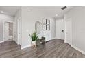 Inviting entryway showcasing stylish decor, wood-look floors, and ample natural light at 12199 Xavier Ave, Port Charlotte, FL 33981