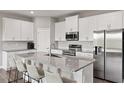 Modern kitchen with granite countertops, stainless steel appliances, and a center island with seating at 12199 Xavier Ave, Port Charlotte, FL 33981